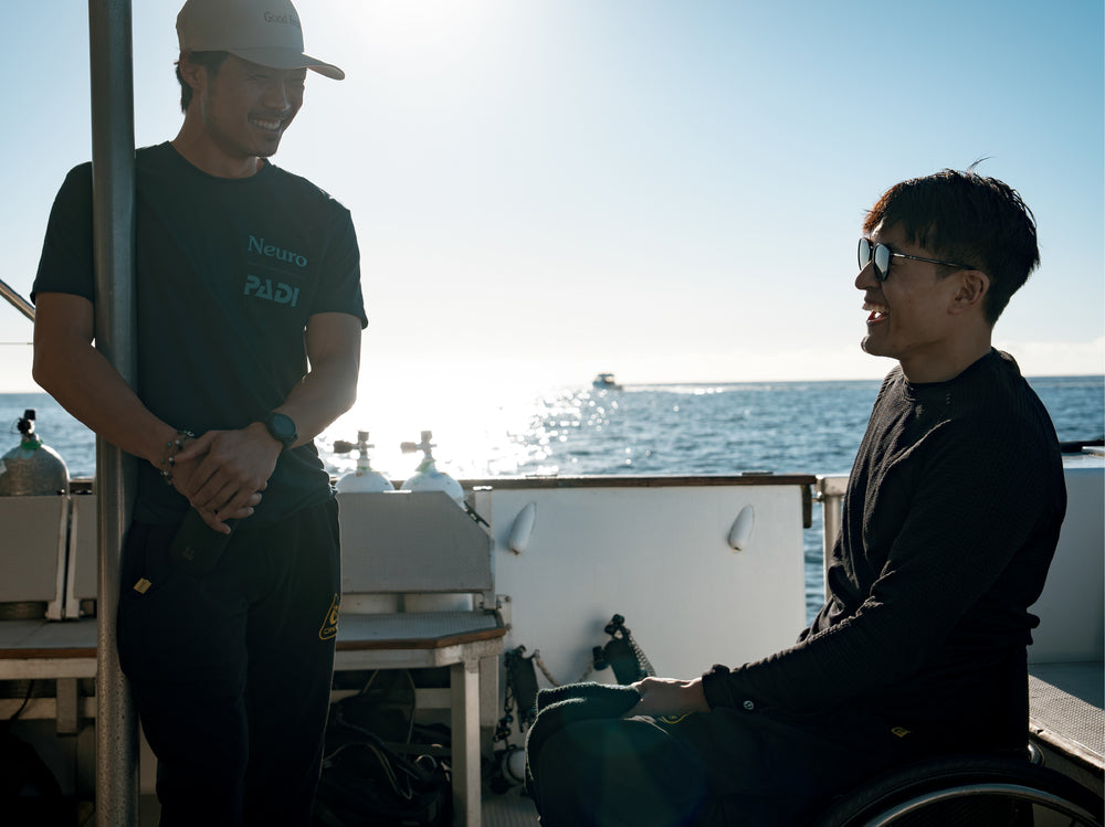 Neuro co-founders smiling on a boat with the ocean in the background